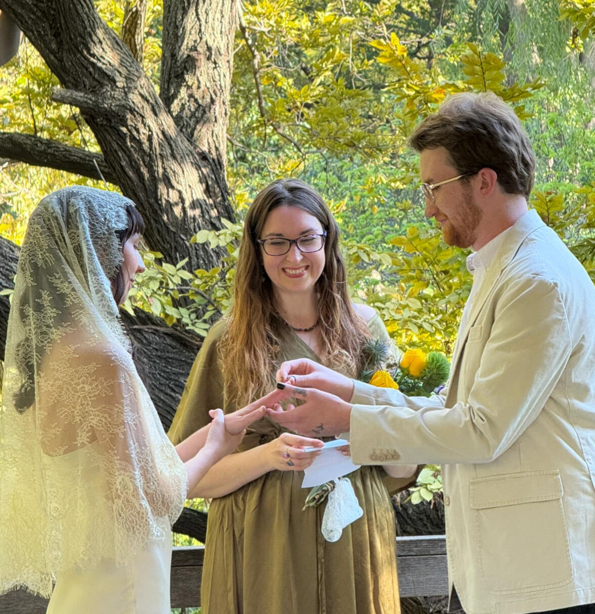Krystal Linnea An image of three people at an outdoor ceremony. Krystal Linnea is honoured to be officiating her son's wedding.